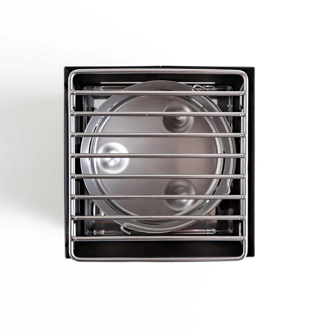 A top view of a luxe tabletop grill, showcasing its sleek design and functional stove features.