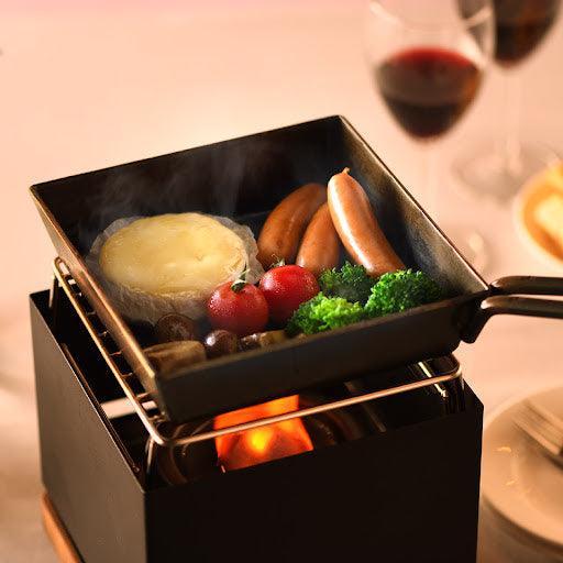 Luxe tabletop grill with mini frying pan offering versatile cooking and efficient meal preparation.