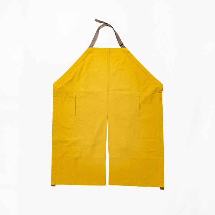 Stylish mustard yellow Japanese apron from our kitchen linens collection, featuring pockets and adjustable straps.
