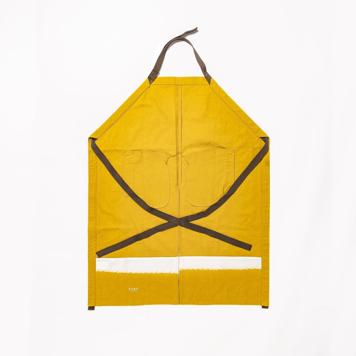 Stylish mustard yellow Japanese apron from our kitchen linens collection, featuring pockets and adjustable straps.