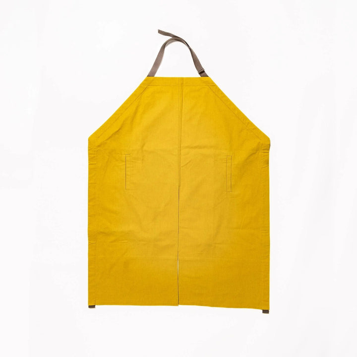 Stylish mustard yellow Japanese apron from our kitchen linens collection, featuring pockets and adjustable straps.