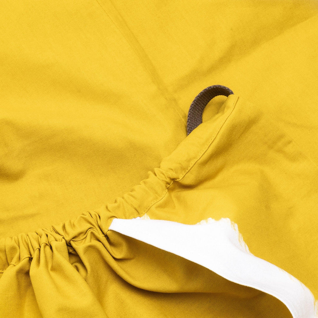 Stylish mustard yellow Japanese apron from our kitchen linens collection, featuring pockets and adjustable straps.