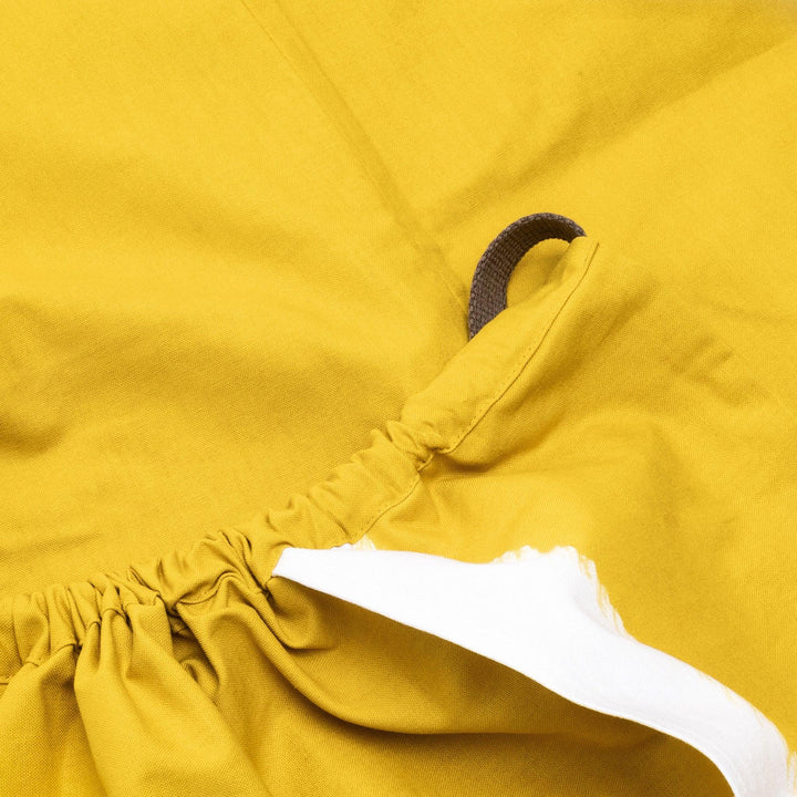 Stylish mustard yellow Japanese apron from our kitchen linens collection, featuring pockets and adjustable straps.
