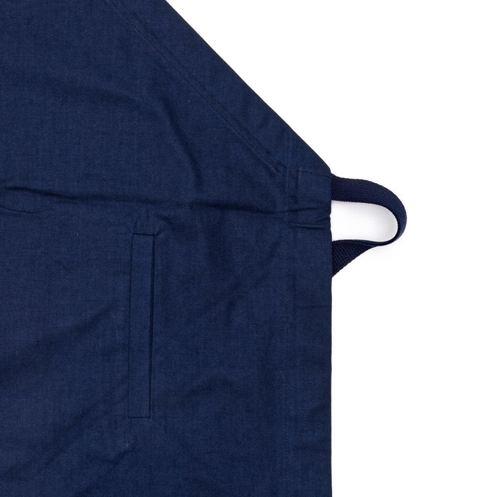 Stylish navy blue Japanese apron from our kitchen linens collection, featuring pockets and adjustable straps.