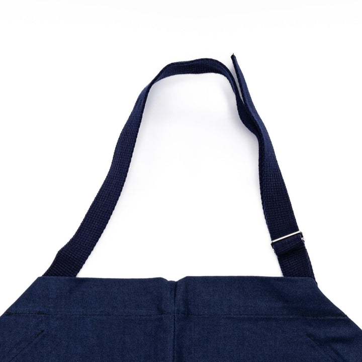 Stylish navy blue Japanese apron from our kitchen linens collection, featuring pockets and adjustable straps.