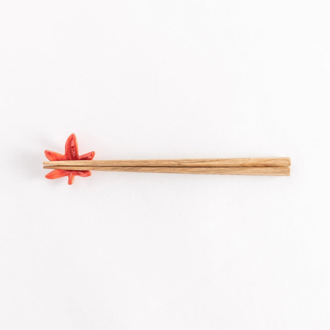Chopsticks resting on the maple leaf chopsticks rest, full view from above.