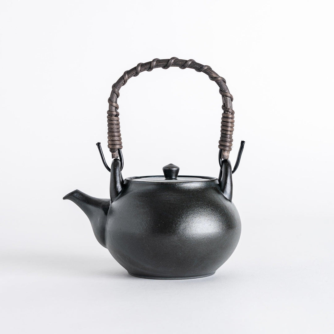 Matte black Japanese tea set featuring teapot and cups offering refined minimalist design for tea time.