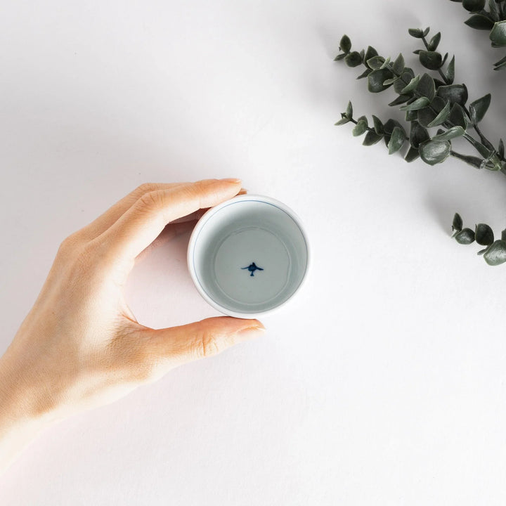 Small white condiment bowl with a blue mesh pattern.