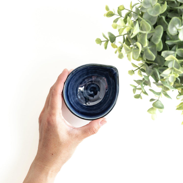 A small condiment bowl in deep, glossy blue.