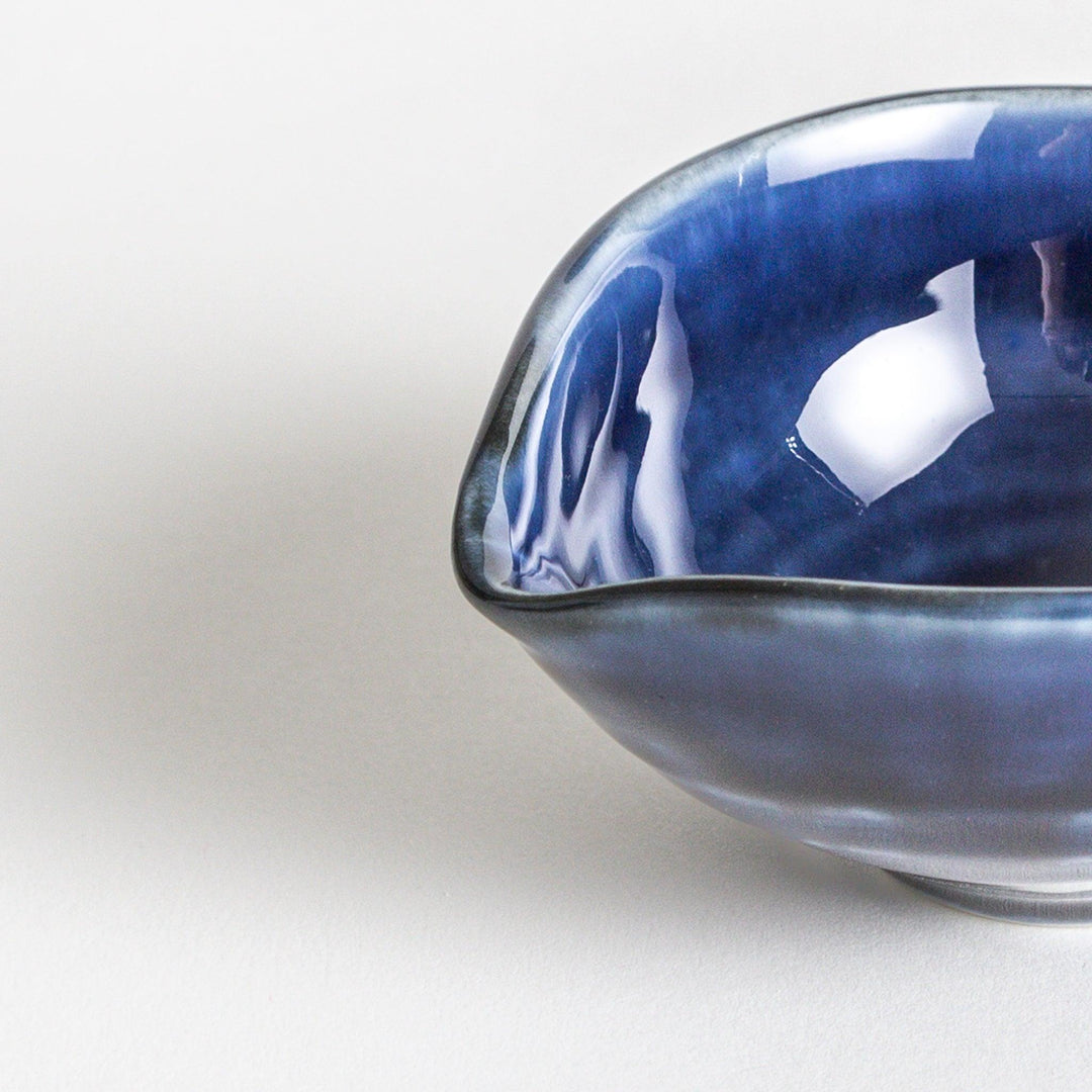 A small condiment bowl in deep, glossy blue.
