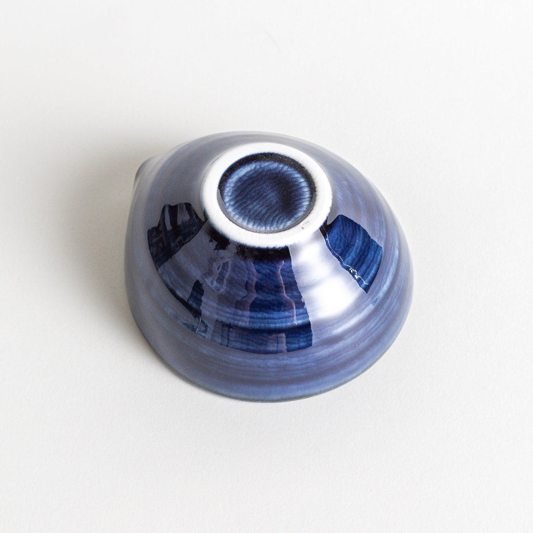 A small condiment bowl in deep, glossy blue.