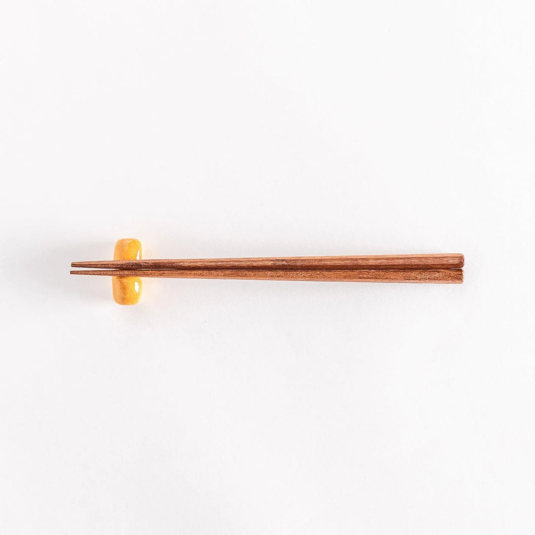 The milk bread chopsticks rest with chopsticks placed across it, photographed to show the full setup.