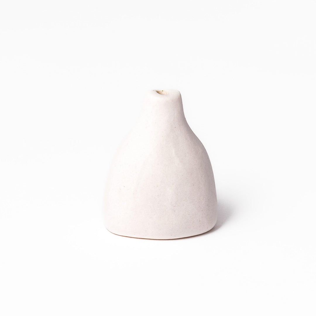 White ceramic bud vase with dried flowers, perfect for adding simple, elegant Japanese-inspired decor to any space.