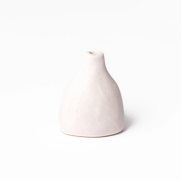 White ceramic bud vase with dried flowers, perfect for adding simple, elegant Japanese-inspired decor to any space.