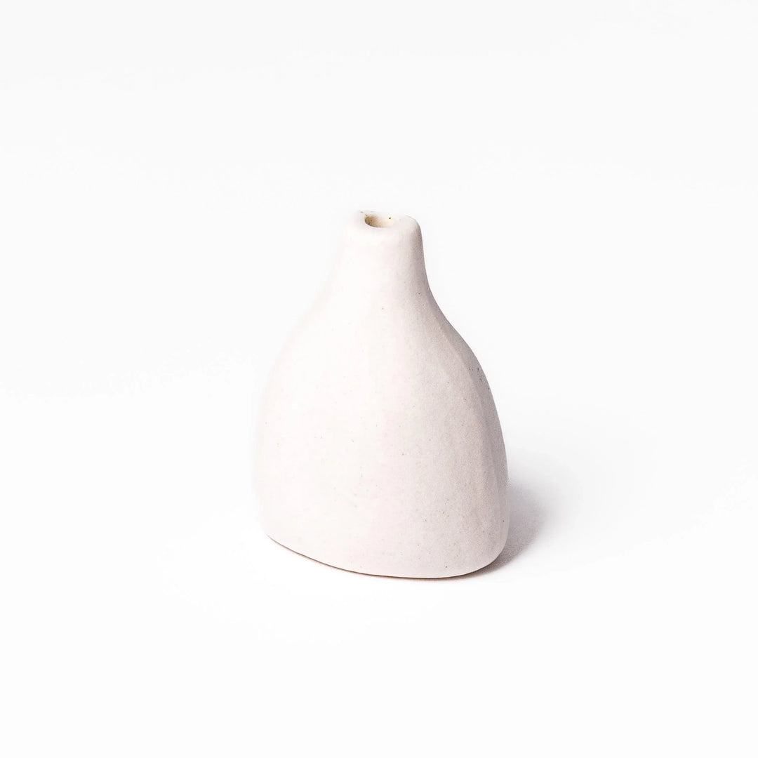 White ceramic bud vase with dried flowers, perfect for adding simple, elegant Japanese-inspired decor to any space.