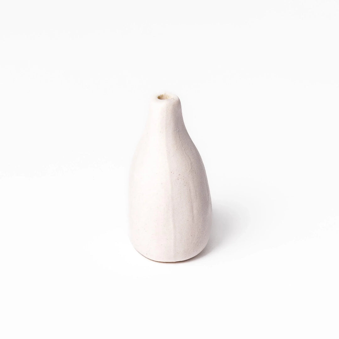 White ceramic bud vase with dried flowers, perfect for adding simple, elegant Japanese-inspired decor to any space.