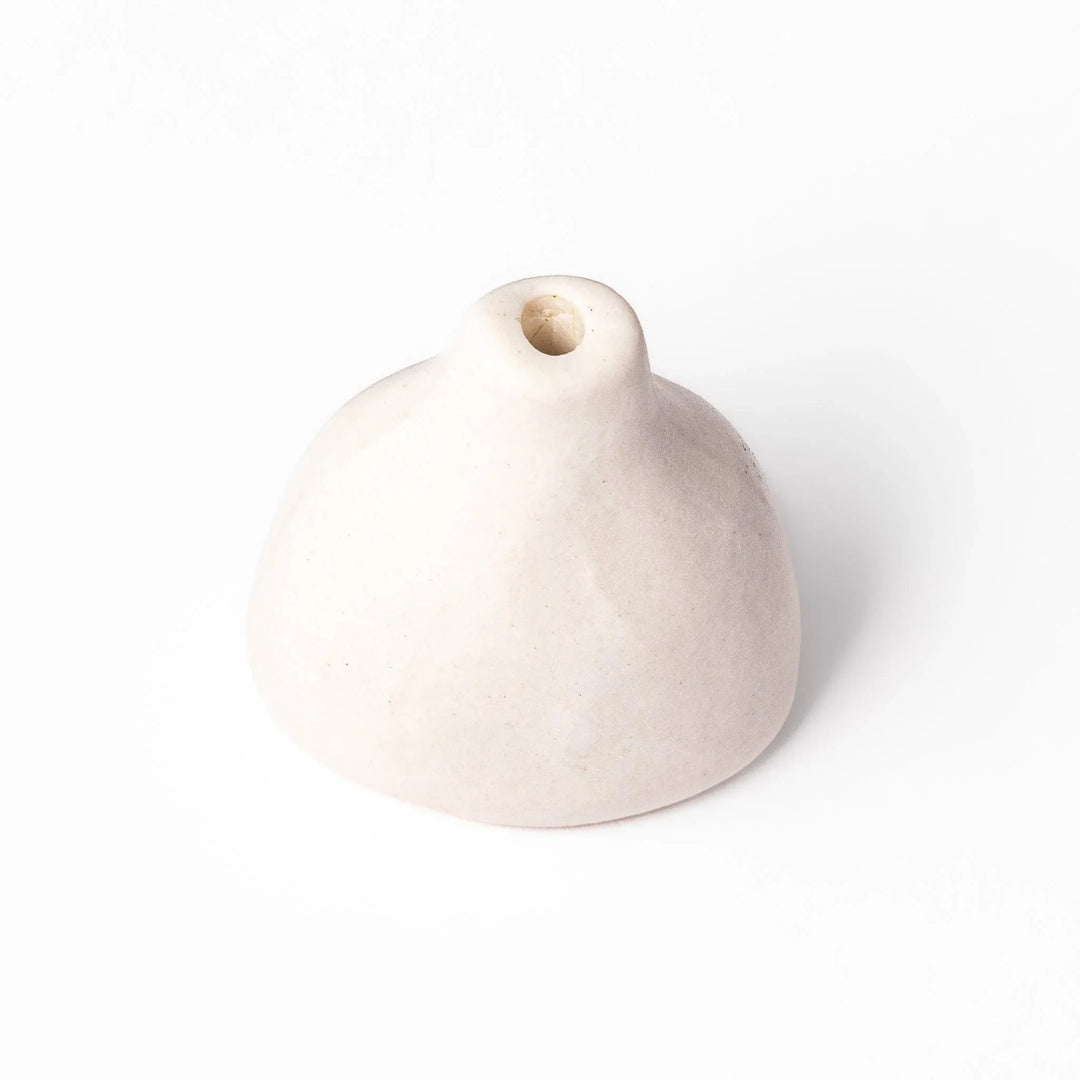 White ceramic bud vase with dried flowers, perfect for adding simple, elegant Japanese-inspired decor to any space.
