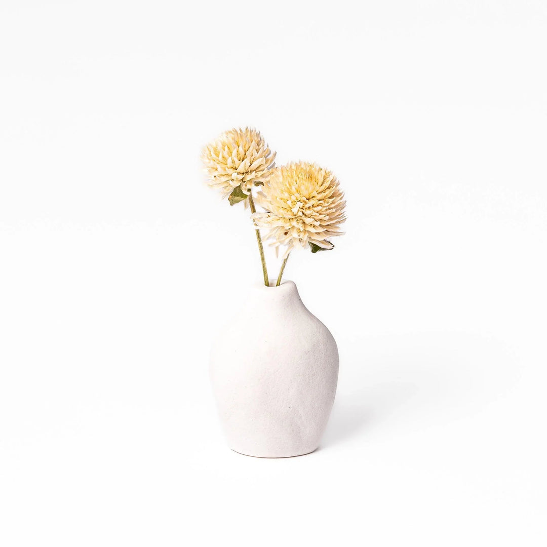 White ceramic bud vase with dried flowers, perfect for adding simple, elegant Japanese-inspired decor to any space.