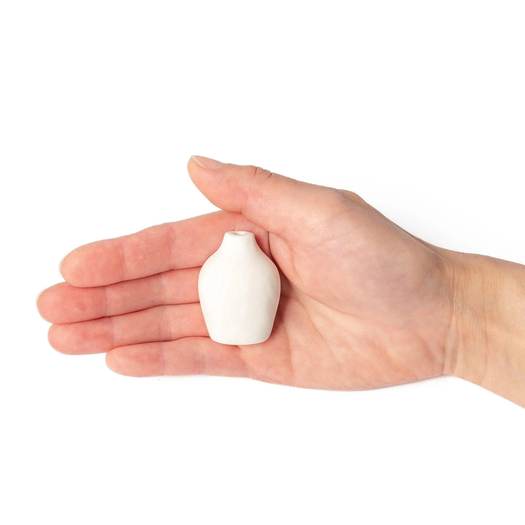White ceramic bud vase with dried flowers, perfect for adding simple, elegant Japanese-inspired decor to any space.