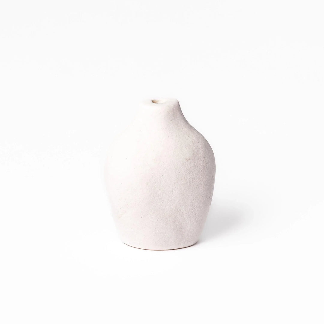 White ceramic bud vase with dried flowers, perfect for adding simple, elegant Japanese-inspired decor to any space.