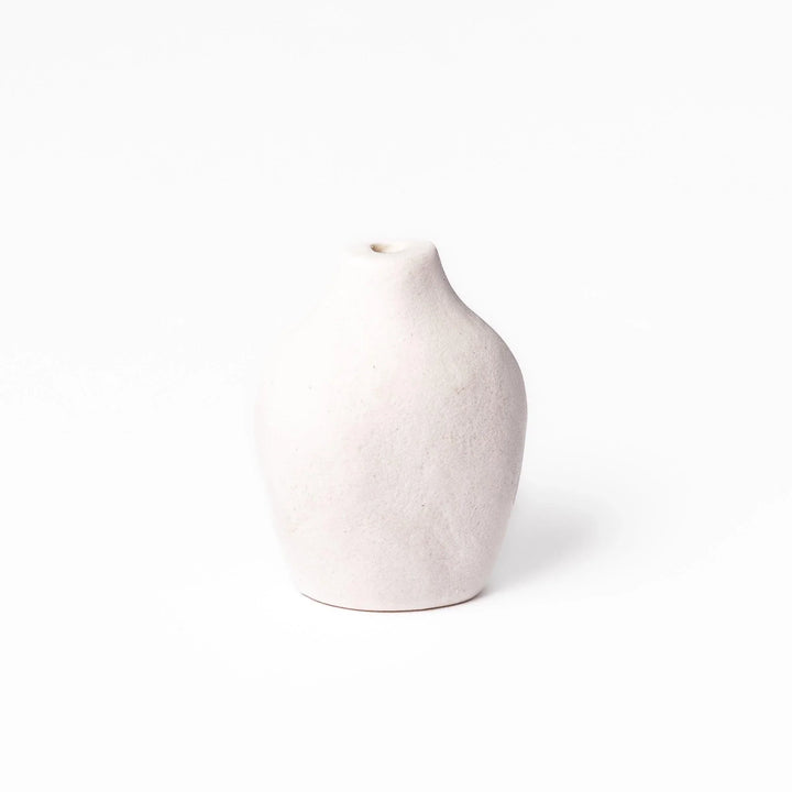 White ceramic bud vase with dried flowers, perfect for adding simple, elegant Japanese-inspired decor to any space.