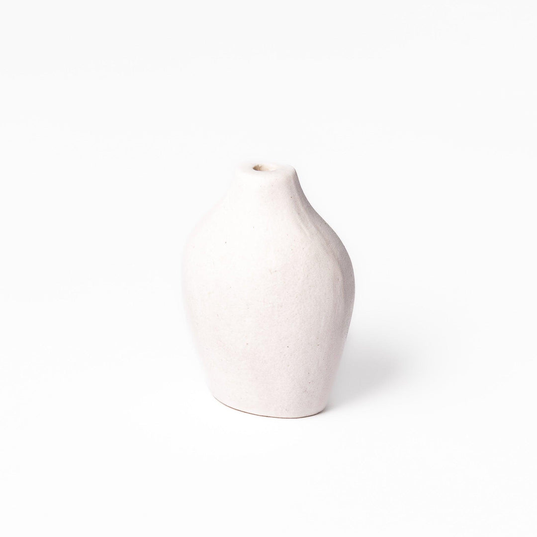 White ceramic bud vase with dried flowers, perfect for adding simple, elegant Japanese-inspired decor to any space.