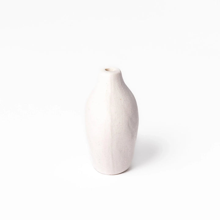 White ceramic bud vase with dried flowers, perfect for adding simple, elegant Japanese-inspired decor to any space.