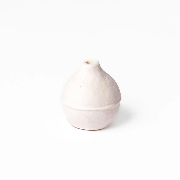 White ceramic bud vase with dried flowers, perfect for adding simple, elegant Japanese-inspired decor to any space.