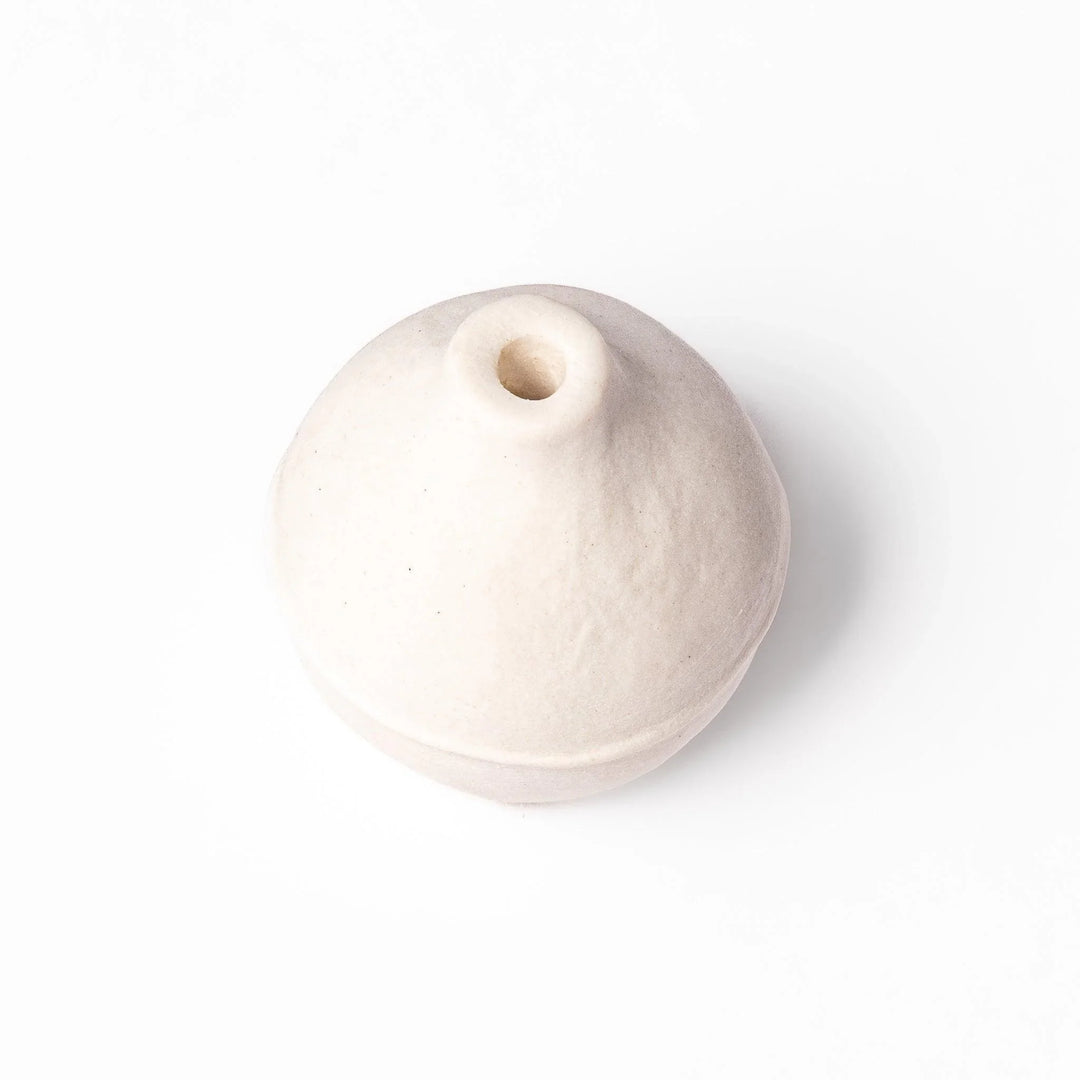 White ceramic bud vase with dried flowers, perfect for adding simple, elegant Japanese-inspired decor to any space.