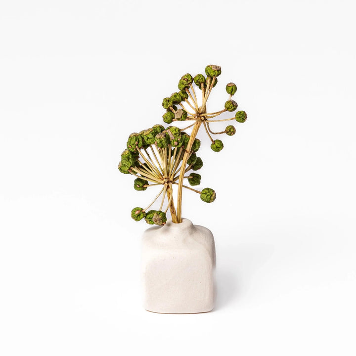 White ceramic bud vase with dried flowers, perfect for adding simple, elegant Japanese-inspired decor to any space.
