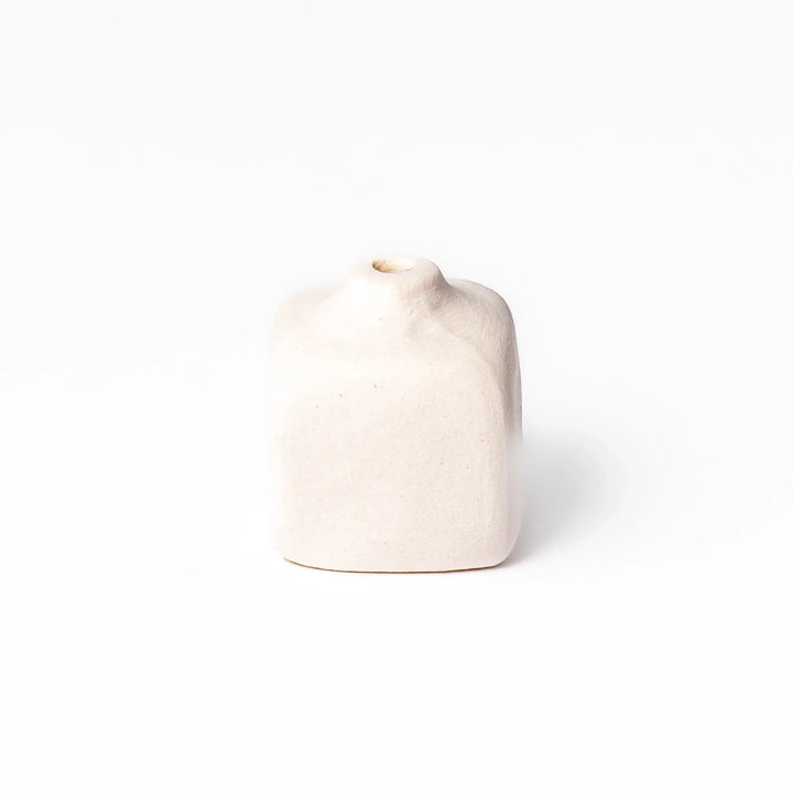 White ceramic bud vase with dried flowers, perfect for adding simple, elegant Japanese-inspired decor to any space.