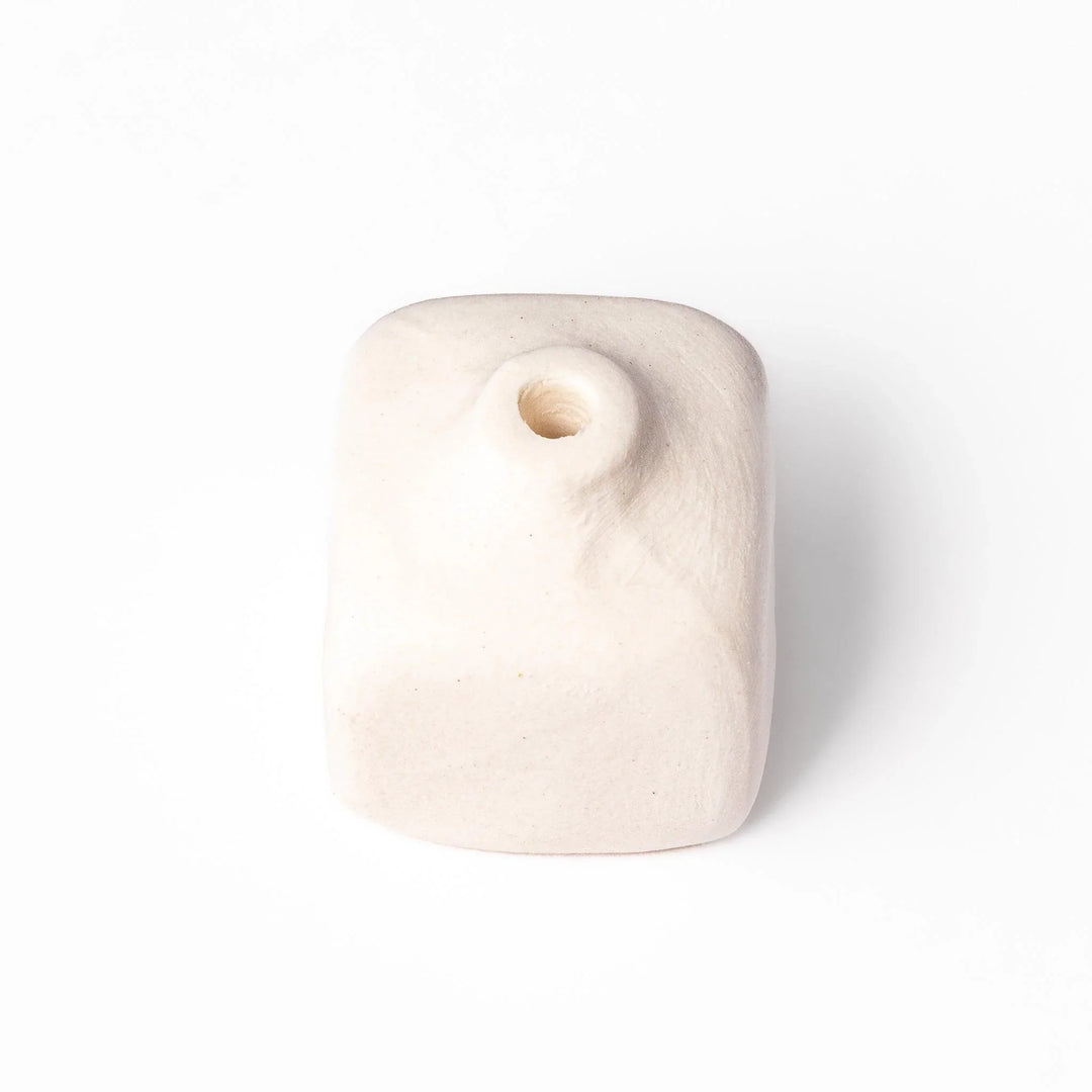 White ceramic bud vase with dried flowers, perfect for adding simple, elegant Japanese-inspired decor to any space.