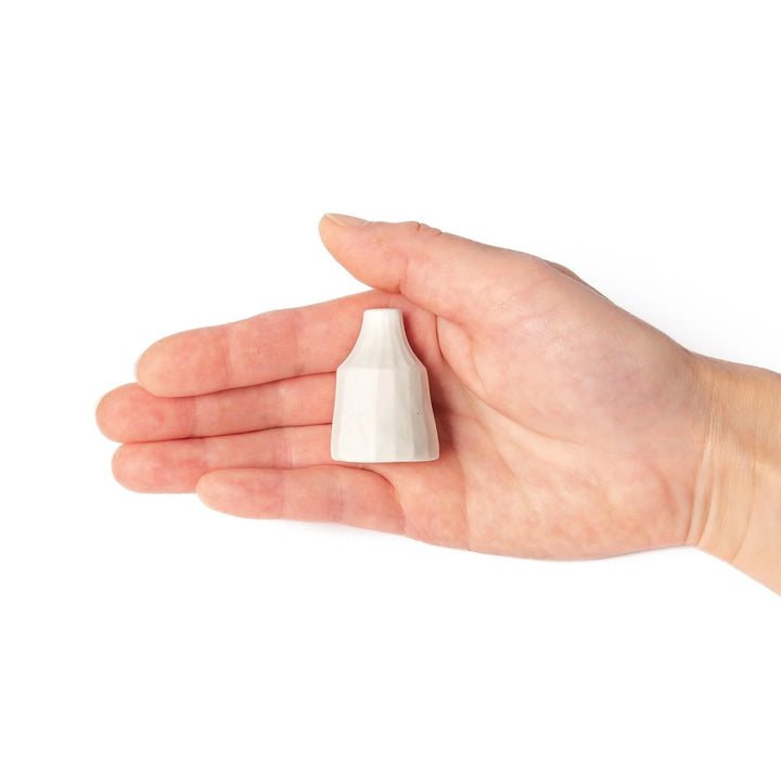 White ceramic bud vase with dried flowers, perfect for adding simple, elegant Japanese-inspired decor to any space.