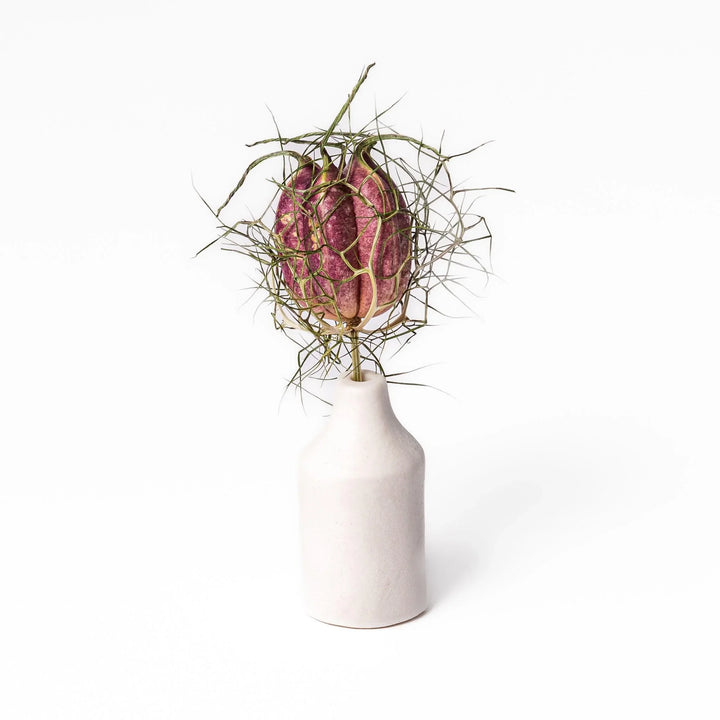 White ceramic bud vase with dried flowers, perfect for adding simple, elegant Japanese-inspired decor to any space.
