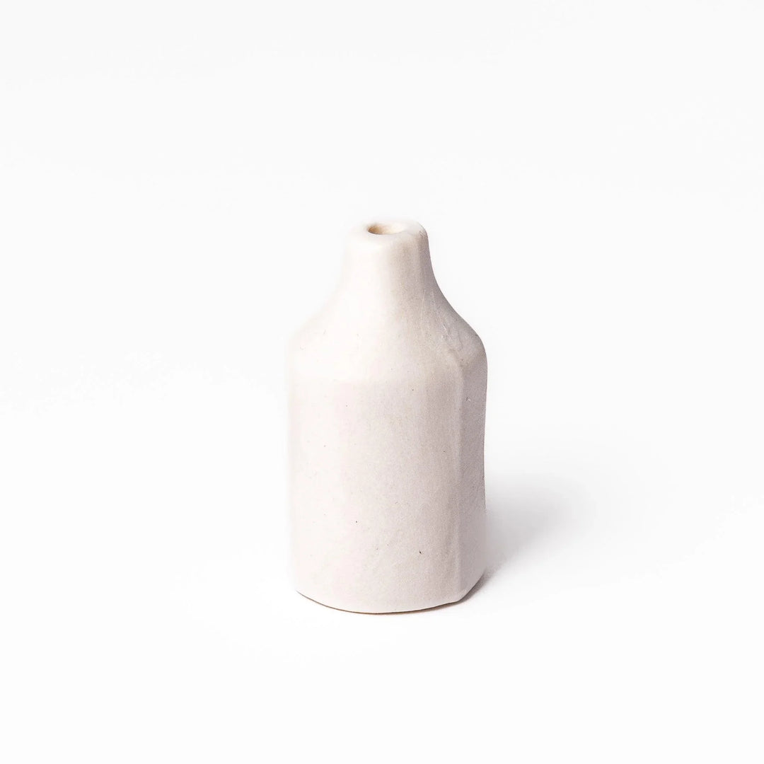 White ceramic bud vase with dried flowers, perfect for adding simple, elegant Japanese-inspired decor to any space.