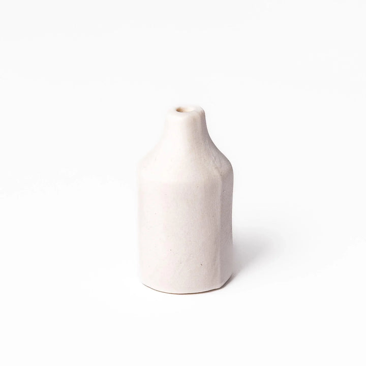 White ceramic bud vase with dried flowers, perfect for adding simple, elegant Japanese-inspired decor to any space.