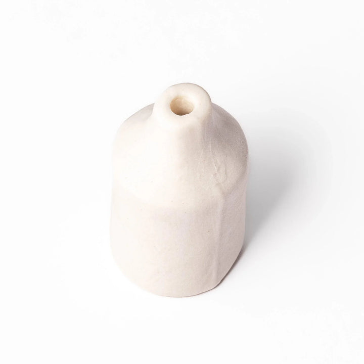 White ceramic bud vase with dried flowers, perfect for adding simple, elegant Japanese-inspired decor to any space.