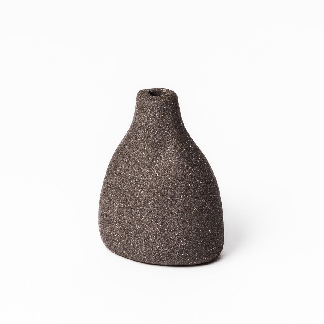 Dark ceramic bud vase with dried flowers, ideal for bringing a modern Japanese touch to any room or table.
