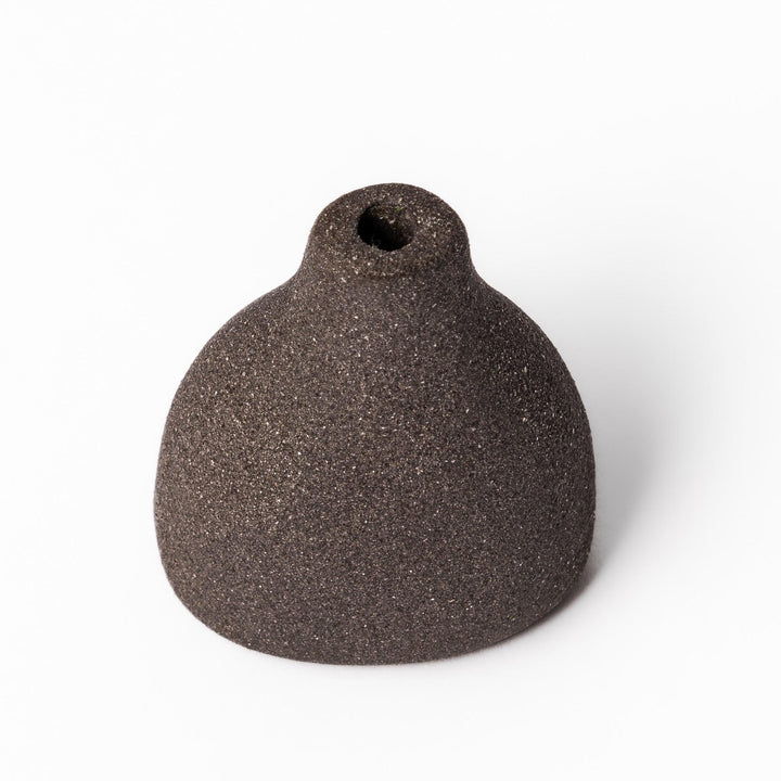 Dark ceramic bud vase with dried flowers, ideal for bringing a modern Japanese touch to any room or table.