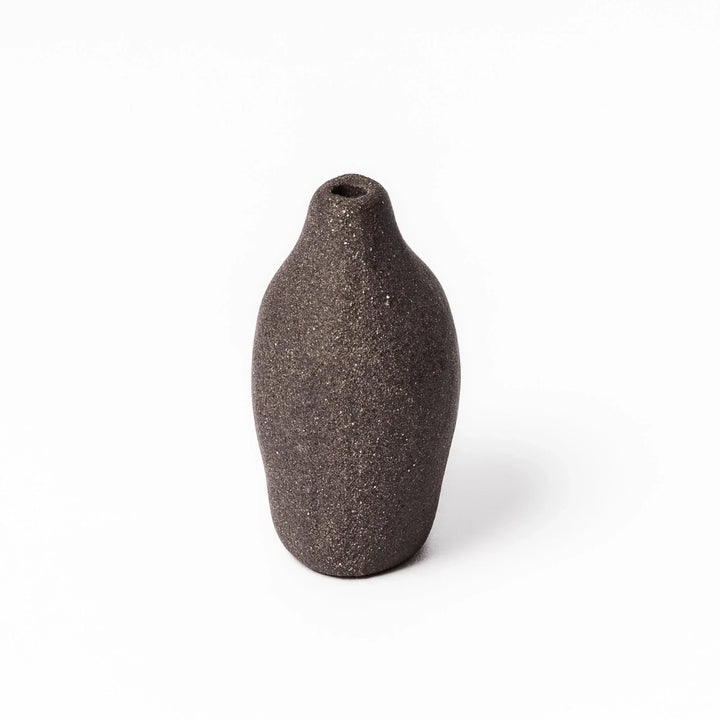 Dark ceramic bud vase with dried flowers, ideal for bringing a modern Japanese touch to any room or table.