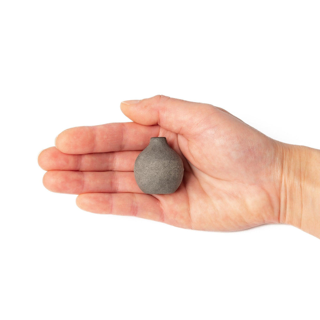 Dark ceramic bud vase with dried flowers, ideal for bringing a modern Japanese touch to any room or table.