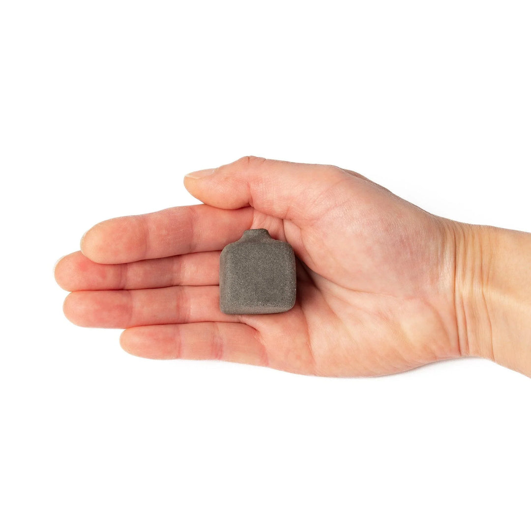 Dark ceramic bud vase with dried flowers, ideal for bringing a modern Japanese touch to any room or table.