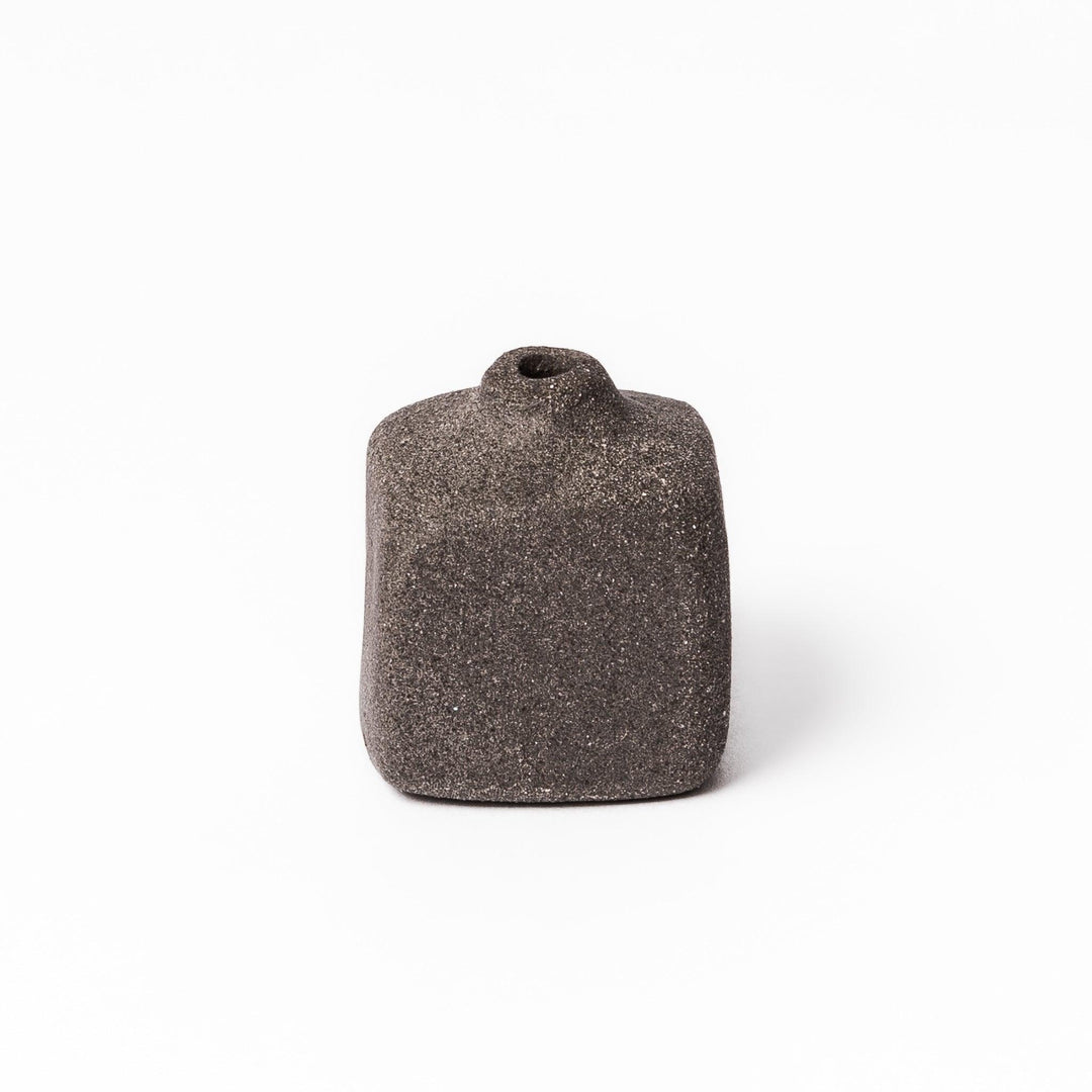 Dark ceramic bud vase with dried flowers, ideal for bringing a modern Japanese touch to any room or table.