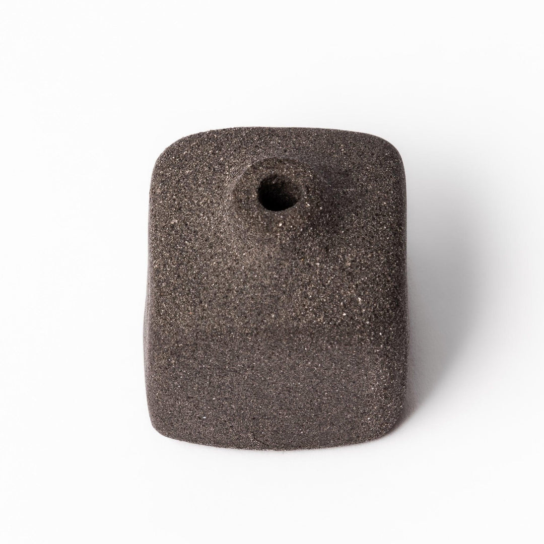 Dark ceramic bud vase with dried flowers, ideal for bringing a modern Japanese touch to any room or table.