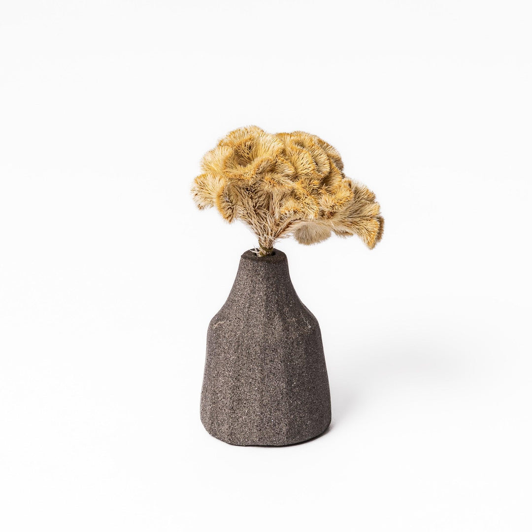 Dark ceramic bud vase with dried flowers, ideal for bringing a modern Japanese touch to any room or table.