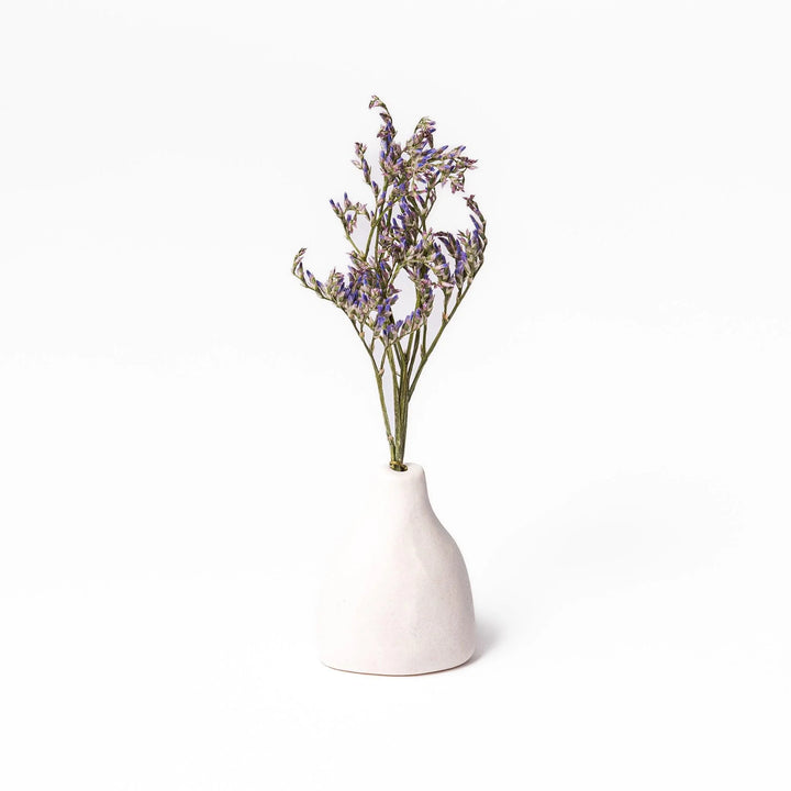 White ceramic bud vase with dried flowers, perfect for adding simple, elegant Japanese-inspired decor to any space.