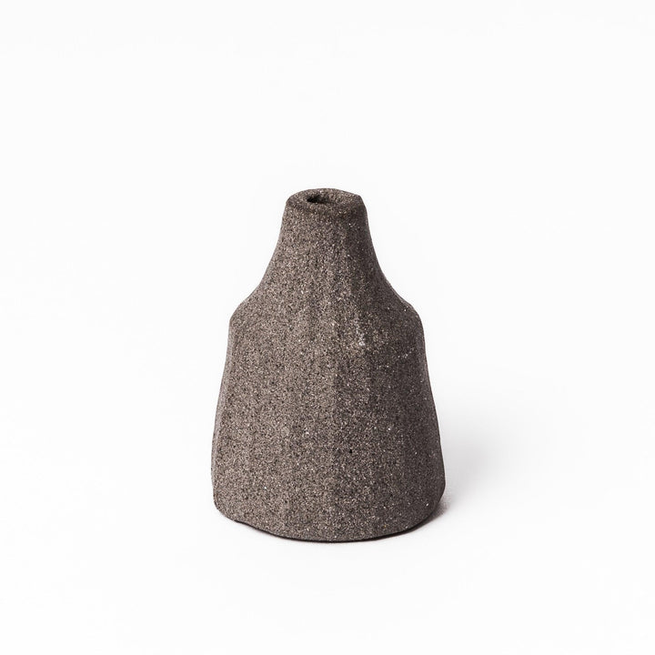 Dark ceramic bud vase with dried flowers, ideal for bringing a modern Japanese touch to any room or table.