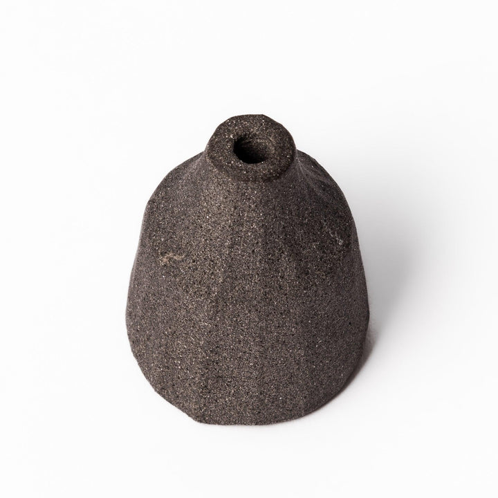 Dark ceramic bud vase with dried flowers, ideal for bringing a modern Japanese touch to any room or table.