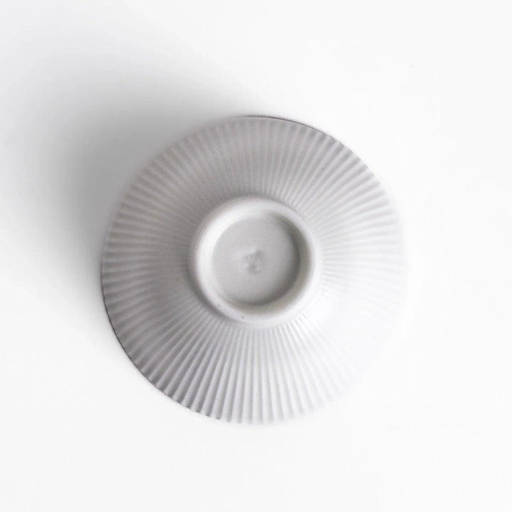 Ribbed white teacup with flared rim and smooth base offering simple elegance for everyday tea rituals.