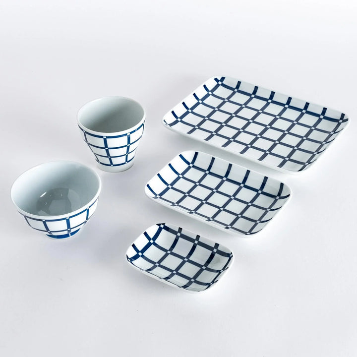 Five pieces featuring the Modern Indigo Lattice design, including two cups, two rectangular plates, and a small dish.
